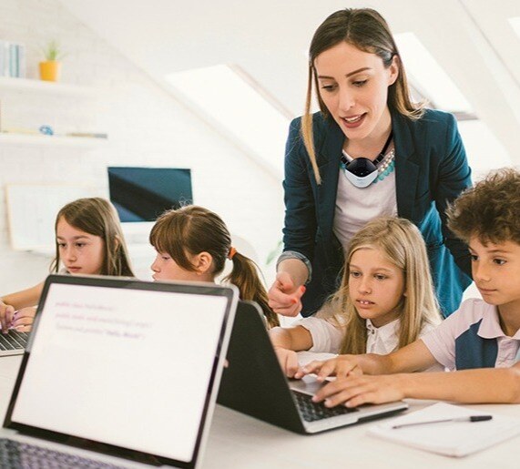 Teacher with kids on laptop copy-1-2