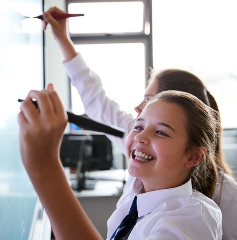 2 Female High School Students at interactive screen 2 Female High School Students at interactive screen